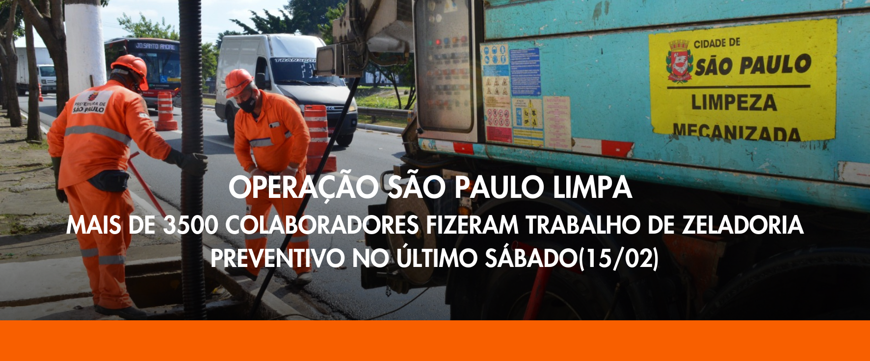 Dois homens vestindo uniformes laranjas e máscaras pretas acompanham o processo de limpeza de uma boca de lobo. A boca de lobo está aberta .